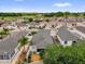 Aerial view of houses in a neighborhood by a lake, highlighting their screened enclosures and mature landscaping at 8932 Se 168Th Sedgwick Pl, The Villages, FL 32162