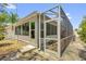 Back exterior featuring a screened lanai with access from a door in the sunroom at 8932 Se 168Th Sedgwick Pl, The Villages, FL 32162