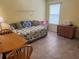 Comfortable bedroom with tile flooring, a daybed, and a window for natural light at 8932 Se 168Th Sedgwick Pl, The Villages, FL 32162