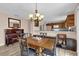 Cozy dining area with a traditional chandelier and a view into the open kitchen at 8932 Se 168Th Sedgwick Pl, The Villages, FL 32162