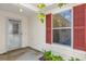 A cozy entryway featuring a storm door, red shutters, and well-maintained vinyl siding at 8932 Se 168Th Sedgwick Pl, The Villages, FL 32162