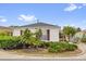 Charming home featuring well-maintained landscaping, red shutters, and a circular driveway at 8932 Se 168Th Sedgwick Pl, The Villages, FL 32162