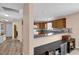 Open kitchen with wood cabinets, modern appliances, and a breakfast bar, creating a welcoming space for cooking and socializing at 8932 Se 168Th Sedgwick Pl, The Villages, FL 32162