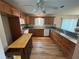 Bright kitchen boasts wooden cabinets, laminate floors, granite countertops, and stainless steel appliances at 8932 Se 168Th Sedgwick Pl, The Villages, FL 32162