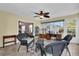 Sunroom featuring wicker furniture, tile flooring and views of the backyard through sliding glass doors at 8932 Se 168Th Sedgwick Pl, The Villages, FL 32162