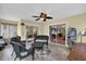 Cozy sunroom with wicker furniture, ceiling fan and views of a well kept backyard at 8932 Se 168Th Sedgwick Pl, The Villages, FL 32162