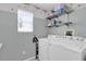 Functional laundry room with modern washer, dryer, and ample storage, simplifying household chores at 8932 Se 168Th Sedgwick Pl, The Villages, FL 32162
