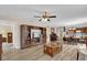 Open-concept living space with wood-look floors connecting the living room, dining area, and kitchen at 8932 Se 168Th Sedgwick Pl, The Villages, FL 32162