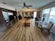 Spacious living room with a piano, hardwood floors, and a large window providing ample natural light at 8932 Se 168Th Sedgwick Pl, The Villages, FL 32162