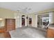 Large main bedroom with a ceiling fan, adjacent walk in closet and sliders to a lanai at 8932 Se 168Th Sedgwick Pl, The Villages, FL 32162