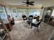 Enclosed sunroom with lots of natural light, tile flooring, and ceiling fan at 8932 Se 168Th Sedgwick Pl, The Villages, FL 32162