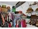 Organized walk in closet with shelving and racks filled with clothes and accessories at 8932 Se 168Th Sedgwick Pl, The Villages, FL 32162