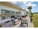 Back patio featuring outdoor seating and a beautiful garden view under a bright sky at 1 Aberdeen Cir, Leesburg, FL 34788