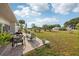 Back yard with an inviting patio, manicured lawn, and lush landscaping, perfect for outdoor enjoyment at 1 Aberdeen Cir, Leesburg, FL 34788