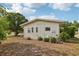 House's backyard featuring well-maintained landscaping and a healthy lawn at 1 Aberdeen Cir, Leesburg, FL 34788