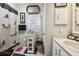 Charming bathroom featuring white fixtures, a themed shower curtain, and decorative accents at 1 Aberdeen Cir, Leesburg, FL 34788