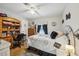 Cozy bedroom with a desk, built-in shelving, and a unique bed frame, complemented by a ceiling fan at 1 Aberdeen Cir, Leesburg, FL 34788