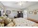 Comfortable bedroom with floral bedding, natural light, and an adjoining bathroom at 1 Aberdeen Cir, Leesburg, FL 34788