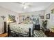Cozy bedroom featuring a ceiling fan, an area rug and decorative furnishings at 1 Aberdeen Cir, Leesburg, FL 34788