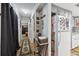 Hallway view, leading to bedroom and featuring art and a decorative console table at 1 Aberdeen Cir, Leesburg, FL 34788