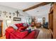 A spacious living area with wood flooring, exposed beams, and cozy seating at 1 Aberdeen Cir, Leesburg, FL 34788