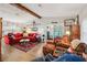 Spacious living room with wood flooring, beamed ceilings, and a comfortable seating area at 1 Aberdeen Cir, Leesburg, FL 34788