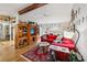 Bright living room with a beamed ceiling, wood floors, and comfortable, inviting furniture at 1 Aberdeen Cir, Leesburg, FL 34788