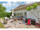 An outdoor patio area with furniture on brick flooring at 1 Aberdeen Cir, Leesburg, FL 34788
