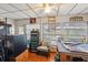 Sunroom featuring a ceiling fan, lots of windows, storage, and seating at 1 Aberdeen Cir, Leesburg, FL 34788