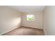 Neutral bedroom with a window offering natural light, and plush carpeting at 10442 Se 179Th Pl, Summerfield, FL 34491