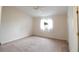 Spacious bedroom featuring a ceiling fan, a window with a view and neutral walls and carpet at 10442 Se 179Th Pl, Summerfield, FL 34491