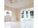 Bright bonus room with tile flooring and sunroom with large windows overlooking the lawn at 10442 Se 179Th Pl, Summerfield, FL 34491