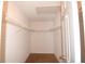 Walk-in closet with white wire shelving and neutral carpeting for organized storage at 10442 Se 179Th Pl, Summerfield, FL 34491