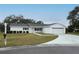 Charming single-story home featuring a well-maintained lawn and two-car garage at 10442 Se 179Th Pl, Summerfield, FL 34491