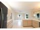 Open kitchen featuring light wood cabinets, white countertops, and tile floors at 10442 Se 179Th Pl, Summerfield, FL 34491