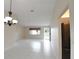Open living area with tile flooring, a chandelier, and a view to the entryway at 10442 Se 179Th Pl, Summerfield, FL 34491