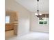 View of the living room with tile floors and adjacent kitchen at 10442 Se 179Th Pl, Summerfield, FL 34491