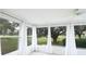 Bright sunroom featuring carpet, large windows, and scenic views at 10442 Se 179Th Pl, Summerfield, FL 34491