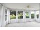 Sunroom with carpet and large windows providing beautiful outdoor views at 10442 Se 179Th Pl, Summerfield, FL 34491