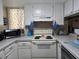 Cozy kitchen with white cabinets, modern appliances, and ample counter space at 1051 S Highland St # D-E, Mount Dora, FL 32757