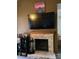 Living room with stone fireplace and mounted television. Comfortable and modern at 1051 S Highland St # D-E, Mount Dora, FL 32757