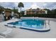 Community pool surrounded by lounge chairs and lush greenery; great for relaxing at 1051 S Highland St # D-E, Mount Dora, FL 32757