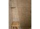 Tiled shower featuring a built-in shelf and a wooden shower seat at 1051 S Highland St # D-E, Mount Dora, FL 32757