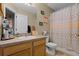 Practical bathroom featuring a single sink vanity and a shower with a decorative elephant patterned curtain at 11126 Oakshore Ln, Clermont, FL 34711