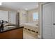 Bright bathroom features a marble countertop vanity and a tiled tub with Jacuzzi jets at 11126 Oakshore Ln, Clermont, FL 34711