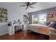 Stylish bedroom with hardwood floors, complemented by bright lighting and a decorative photo wall at 11126 Oakshore Ln, Clermont, FL 34711
