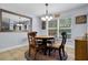 Dining room features wood table, four chairs, and decorative accents at 11126 Oakshore Ln, Clermont, FL 34711