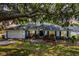 Charming single story home with lush landscaping, shutters, and a two car garage at 11126 Oakshore Ln, Clermont, FL 34711