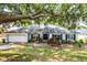 Charming single story home with lush landscaping, shutters, and a two car garage at 11126 Oakshore Ln, Clermont, FL 34711