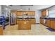 Open kitchen features stainless steel appliances, tile floors, and a breakfast bar at 11126 Oakshore Ln, Clermont, FL 34711
